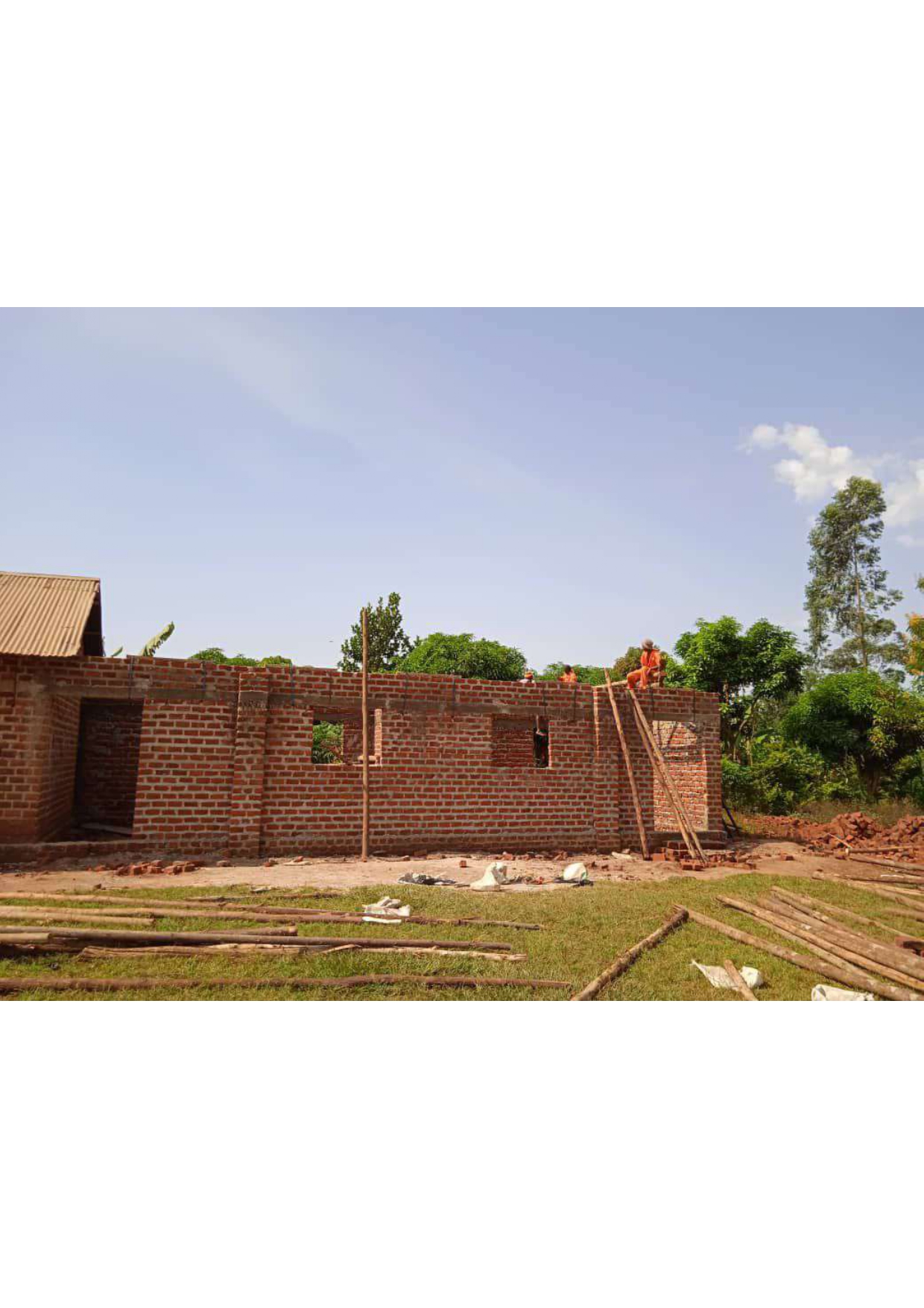 Construction team raising classroom walls